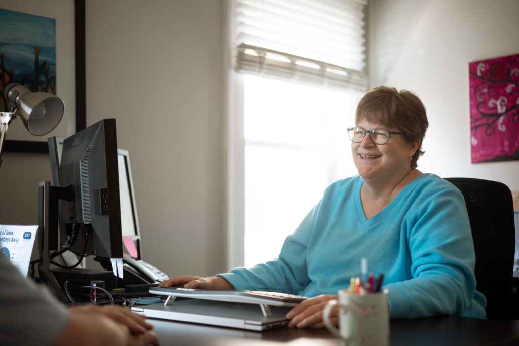 Smiling woman at desk with computer