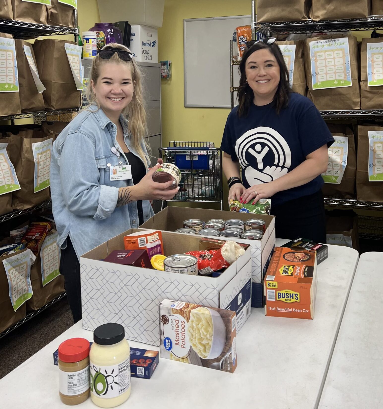 Two women organizing food donations.