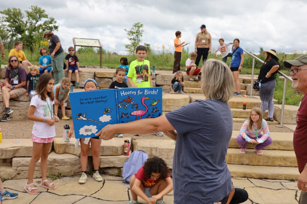Children engaged in outdoor reading activity