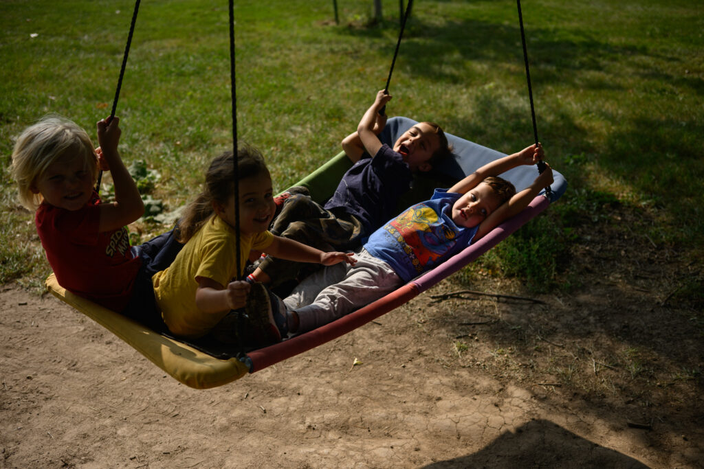 Children playing on a swing together.