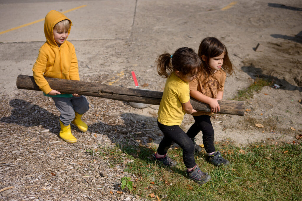 Children carrying a log together