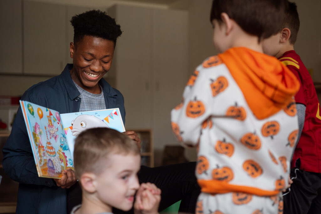 Adult reading to joyful children
