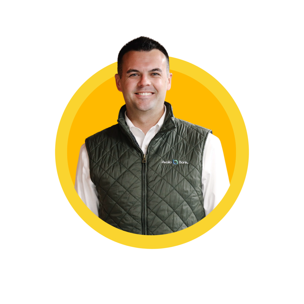 Smiling man in green vest