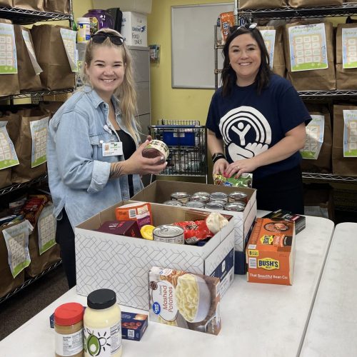 Two women organizing food donations.