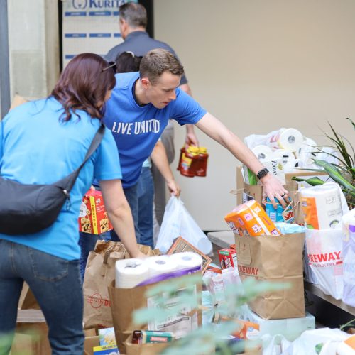 Volunteers sorting donated food items