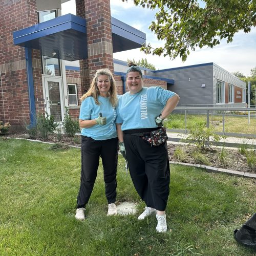 Two women in matching blue shirts